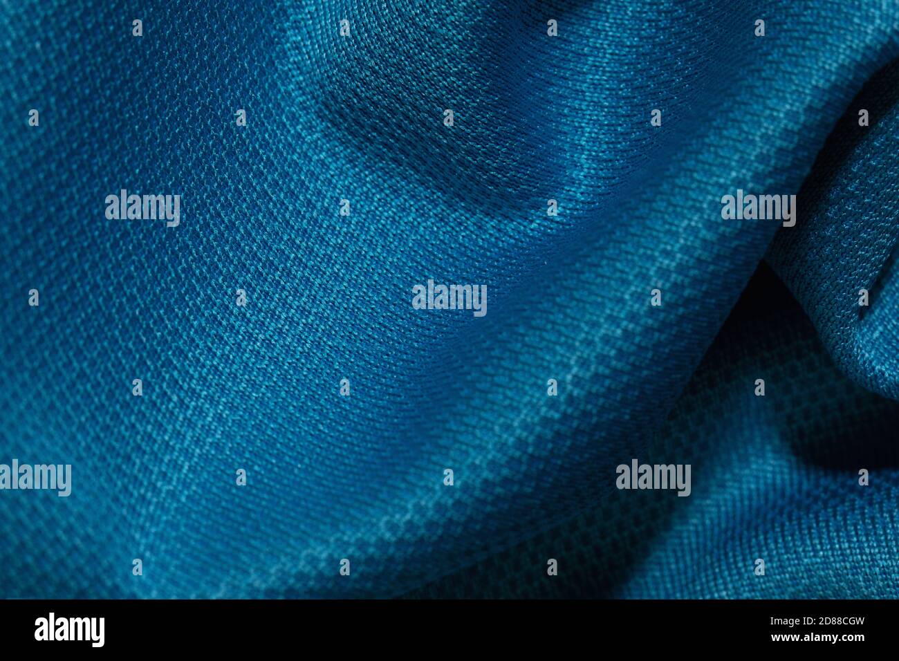 Blue crumpled fabric background. Abstract texture, empty template. Selective focus. Stock Photo