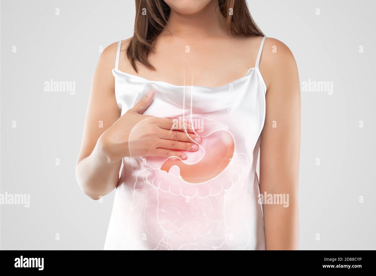A woman in white dress suffering from acid reflux or GERD on a light ...