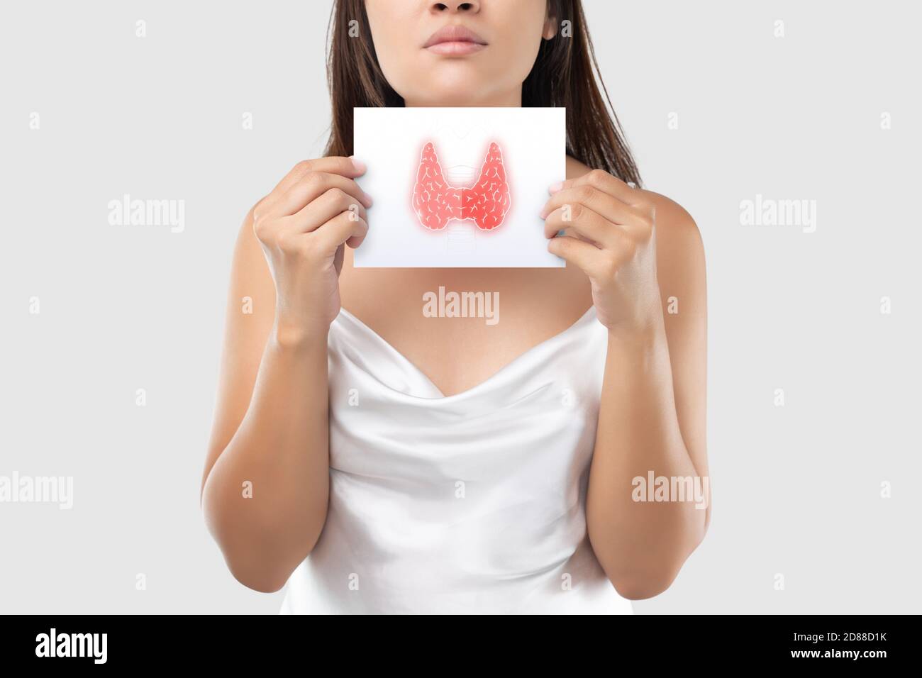 Illustration of the thyroid in the white paper is on the woman's neck. Female thyroid gland control. Sore throat of a people against a light gray back Stock Photo