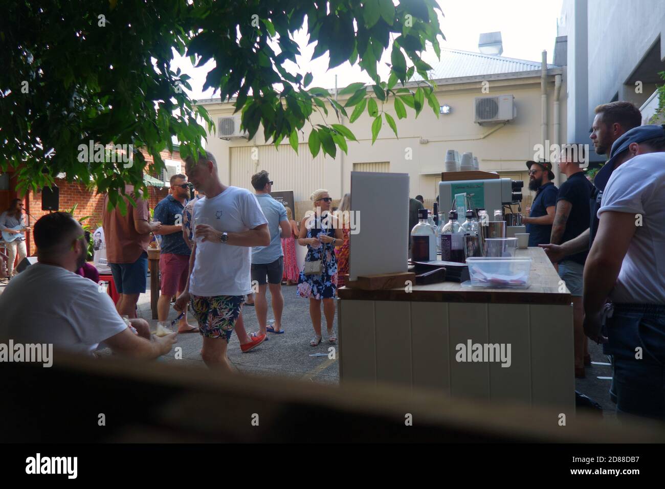 People drinking at socially distanced outdoor Wolf Lane Distillery, Cairns, Queensland, Australia. No MR or PR Stock Photo