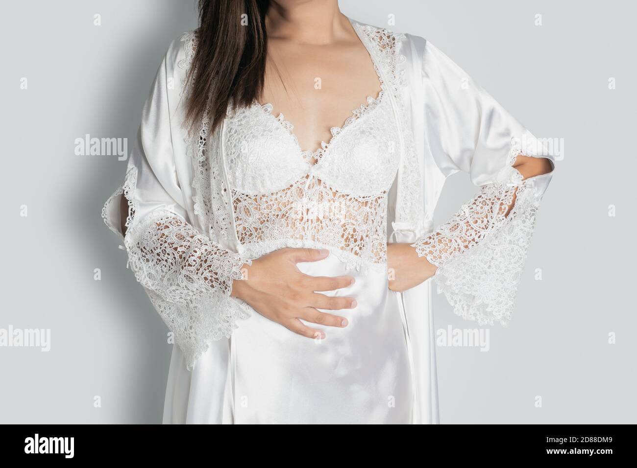 Phetchaburi / Thailand - June 27 2020 Stomach ache because of gastritis or bloating that are sign of , stomach acid trouble on grey background, Women Stock Photo