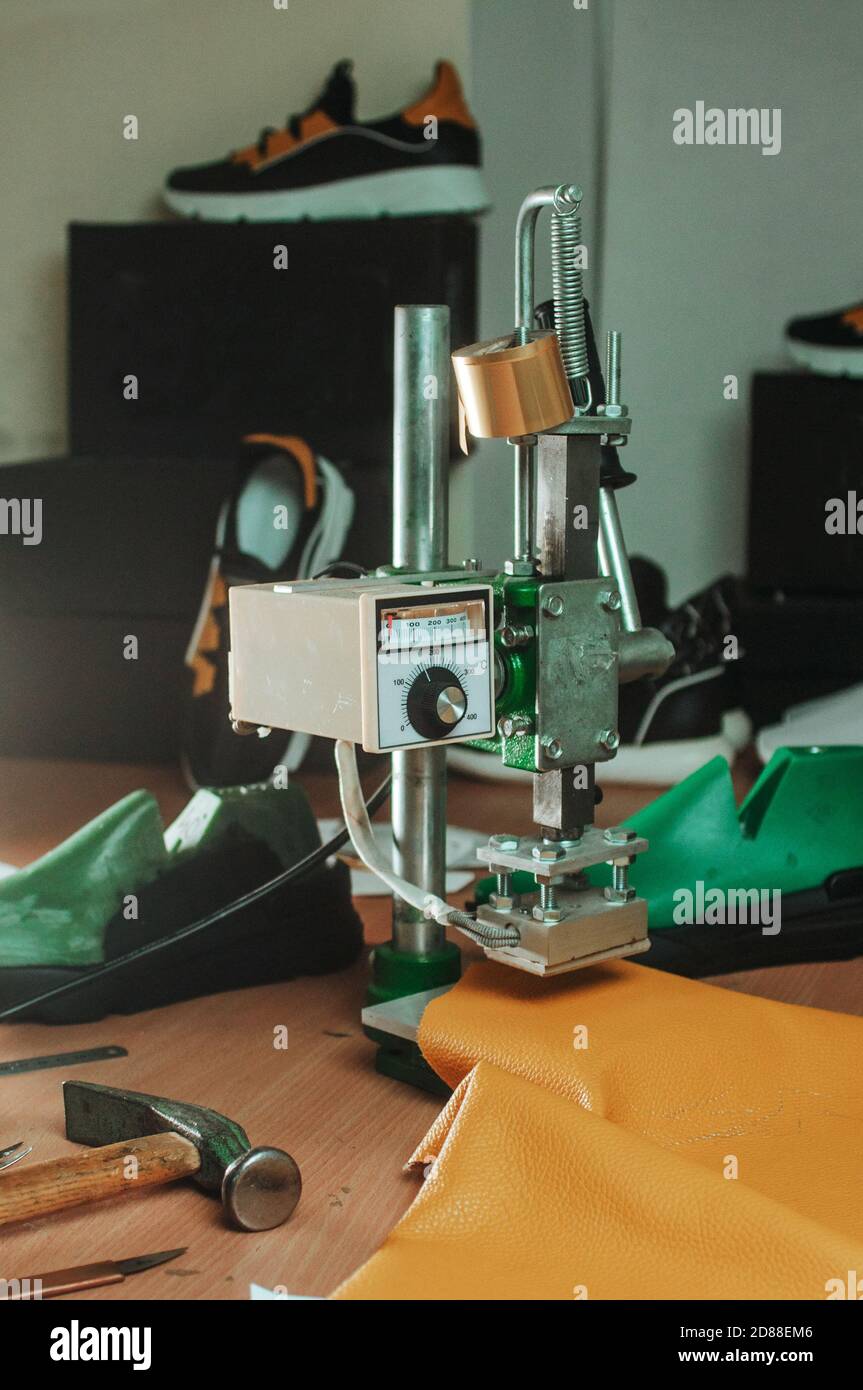 Stamp press making a stamp on a leather Stock Photo Alamy