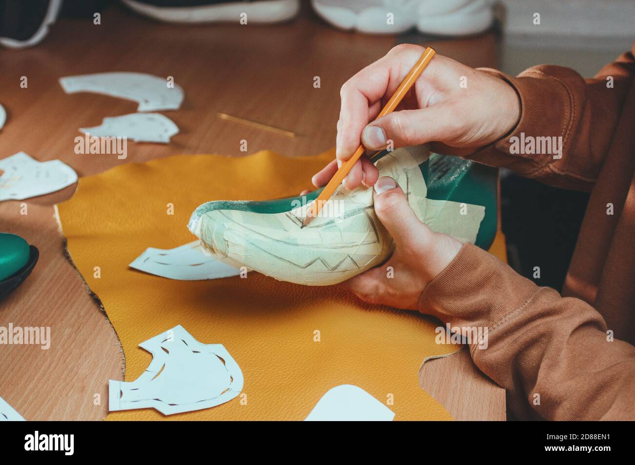 Shoemaker drawing a pattern on the shoe model Stock Photo Alamy