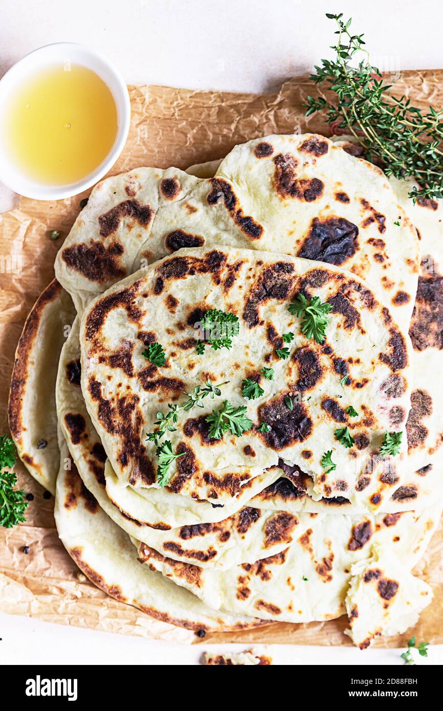 Indian homemade traditional flatbread with fresh parsley and olive oil