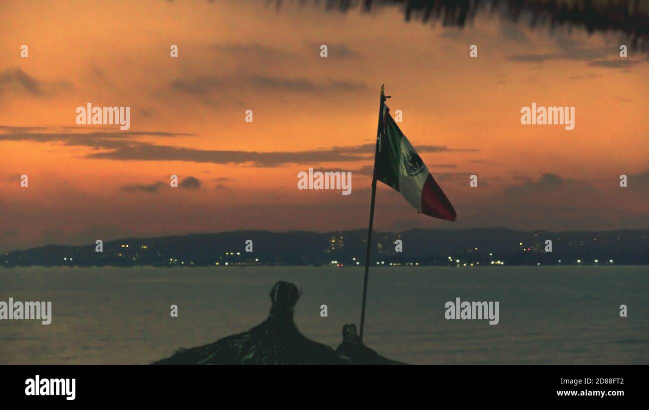 Mexican Flag on the coast of Riviera Nayarit taken at sunset Stock
