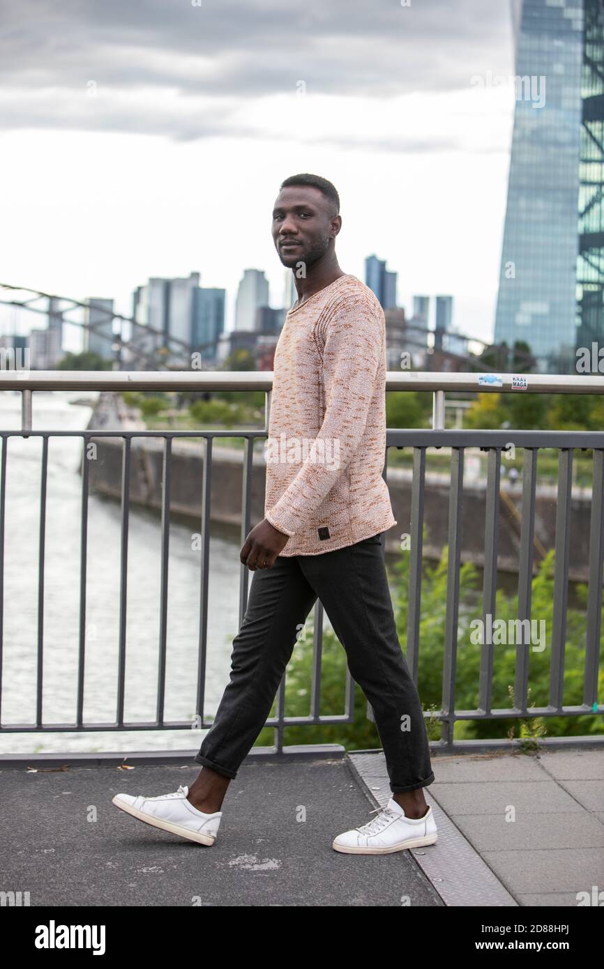 Handsome black man in sweater walking 
