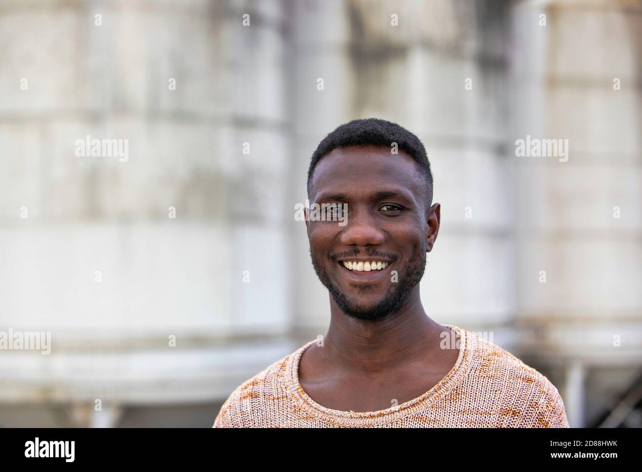 Young black man smiling at camera. Portrait. Medium shot. Stock Photo