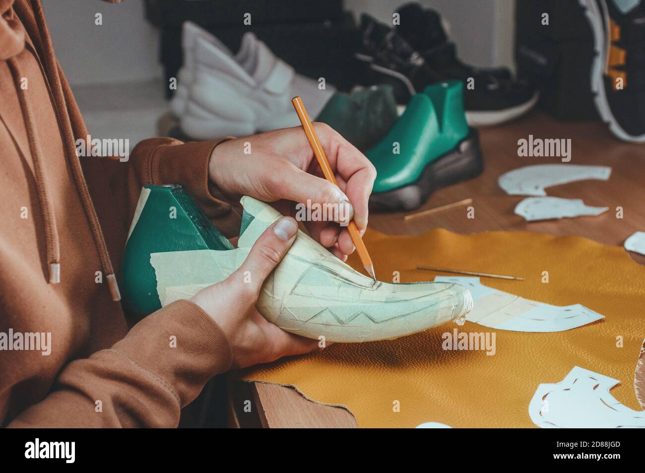 Shoemaker drawing a pattern on the shoe model Stock Photo Alamy