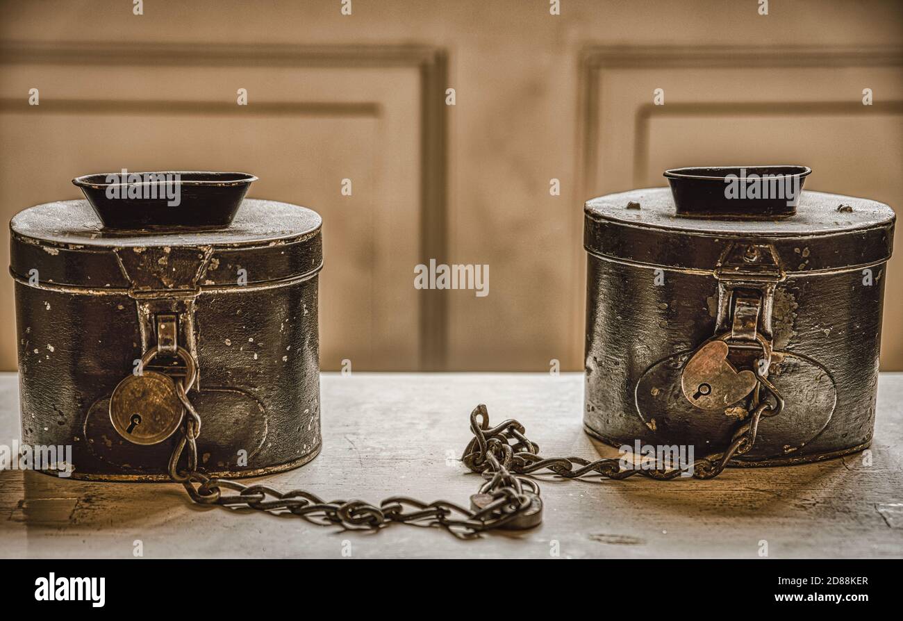 Old offer boxes in a church bear religious, mercy and charity image. Financial illustration features church offer cases that convey economical concept Stock Photo