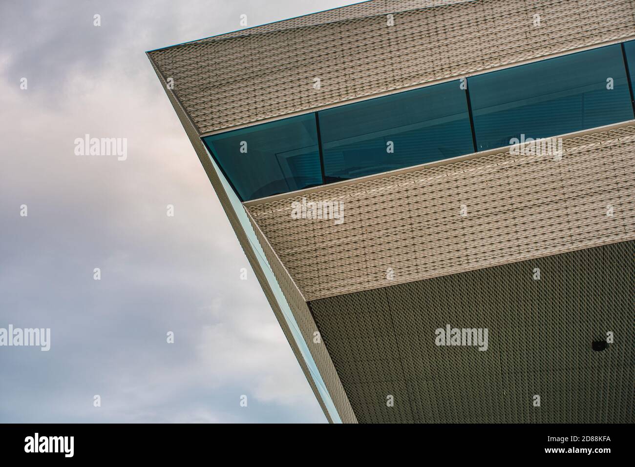 A detailed edge of a contemporary building facade conveys a sense of utter modernity as its edgy features rise against a dramatic sky. Aarhus, Denmark Stock Photo