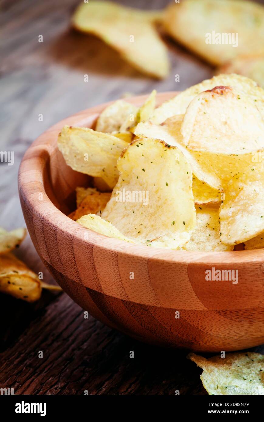 Potato chips, unhealthy food, wood background, selective focus Stock