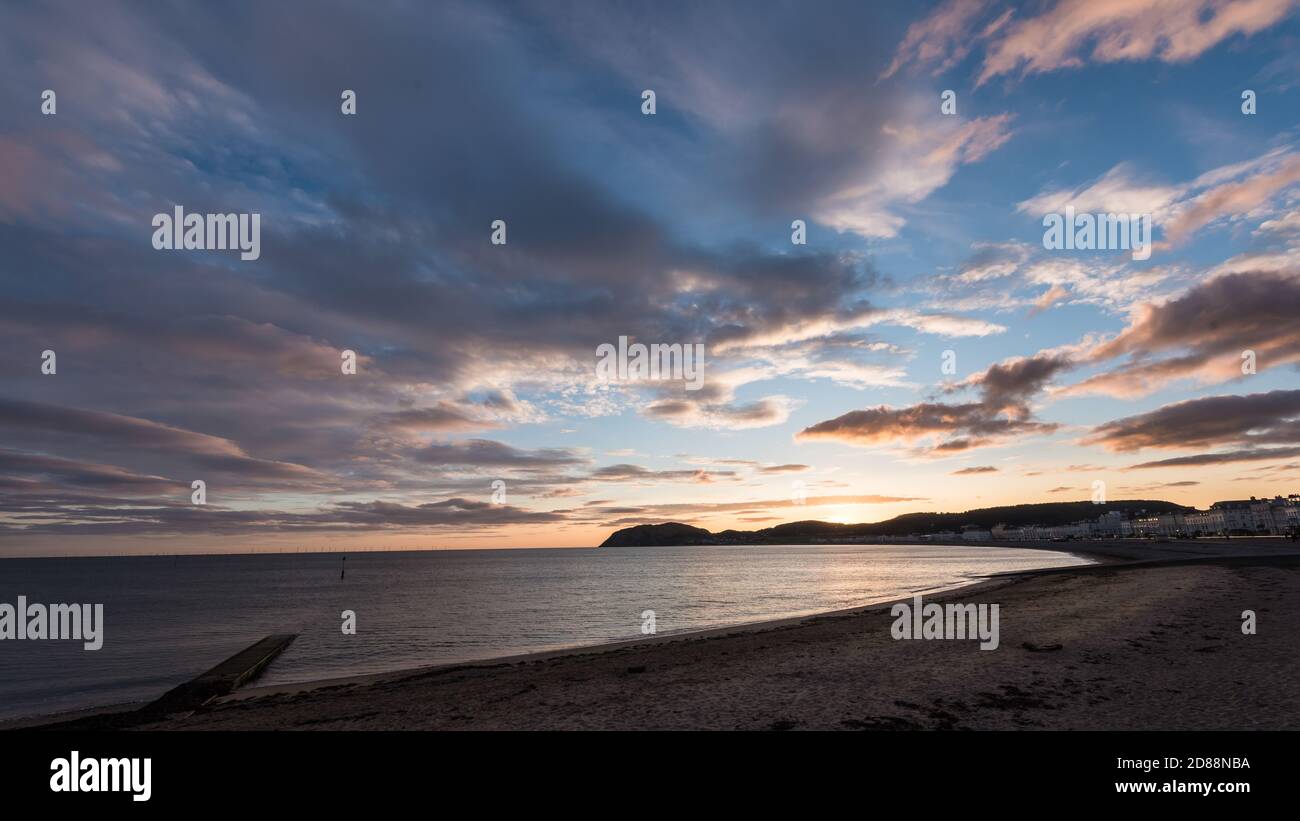 Morning view of Llandudno,wales beach with golden blue cloudy sky in United Kingdom Stock Photo