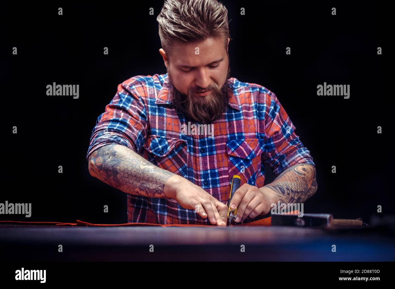 Artisan demostrating leather cutting process Stock Photo
