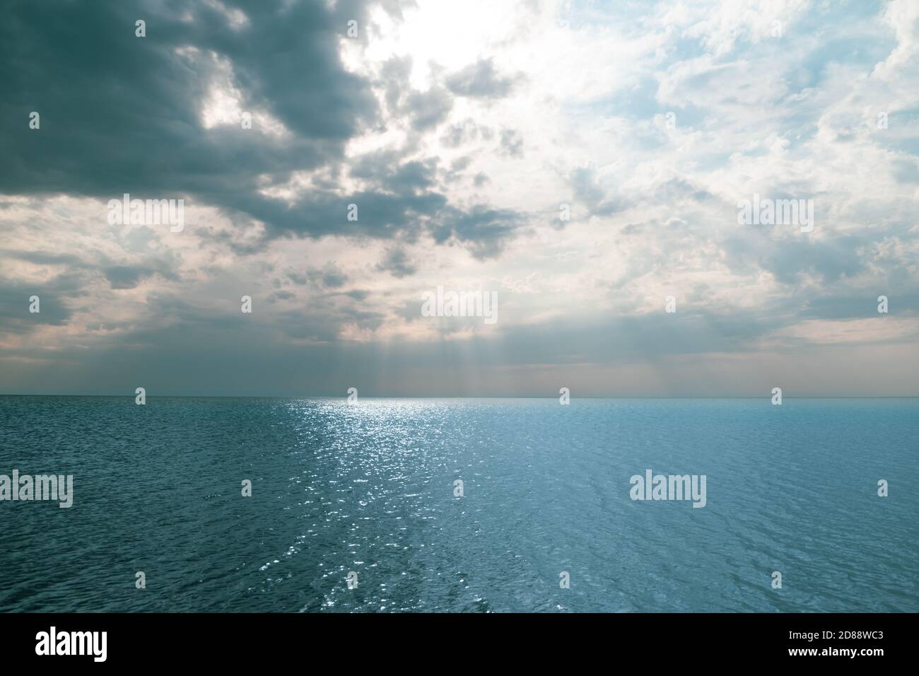 blue sea and cloudy sky over it. Blue Sea sky and Clouds with sun behind Stock Photo