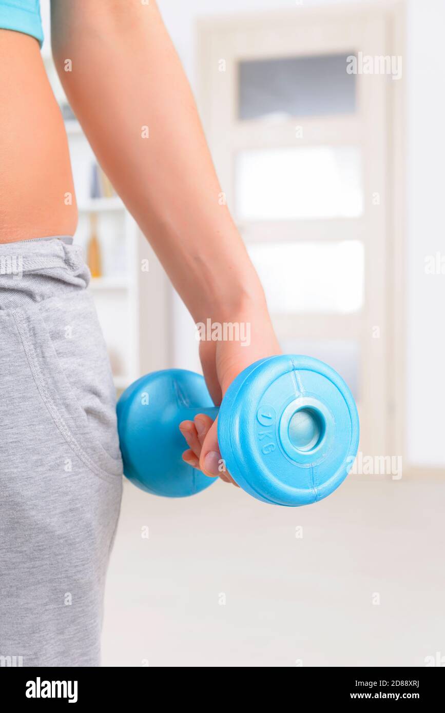 Young girl exercises with dumbbells Stock Photo - Alamy