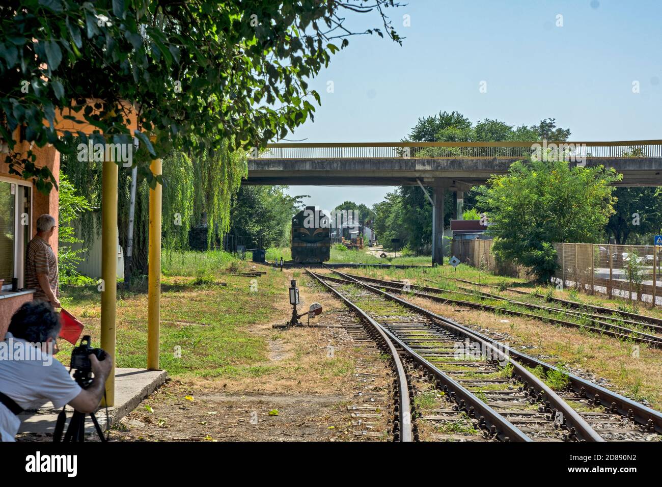 Zrenjanin,Serbia,August 31,2020.Diesel locomotives 661-243 of Serbian railways leave the station and pass under the overpass.Photographer and a railro Stock Photo