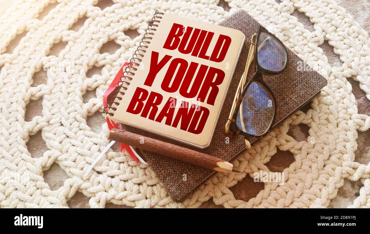 Build Your Brand words on copybook. Pen, glasses. Marketing business concept. Stock Photo