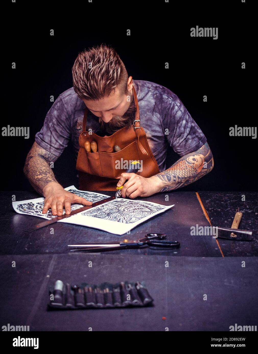 Leather Artisan forms new leather product at the work area Stock Photo