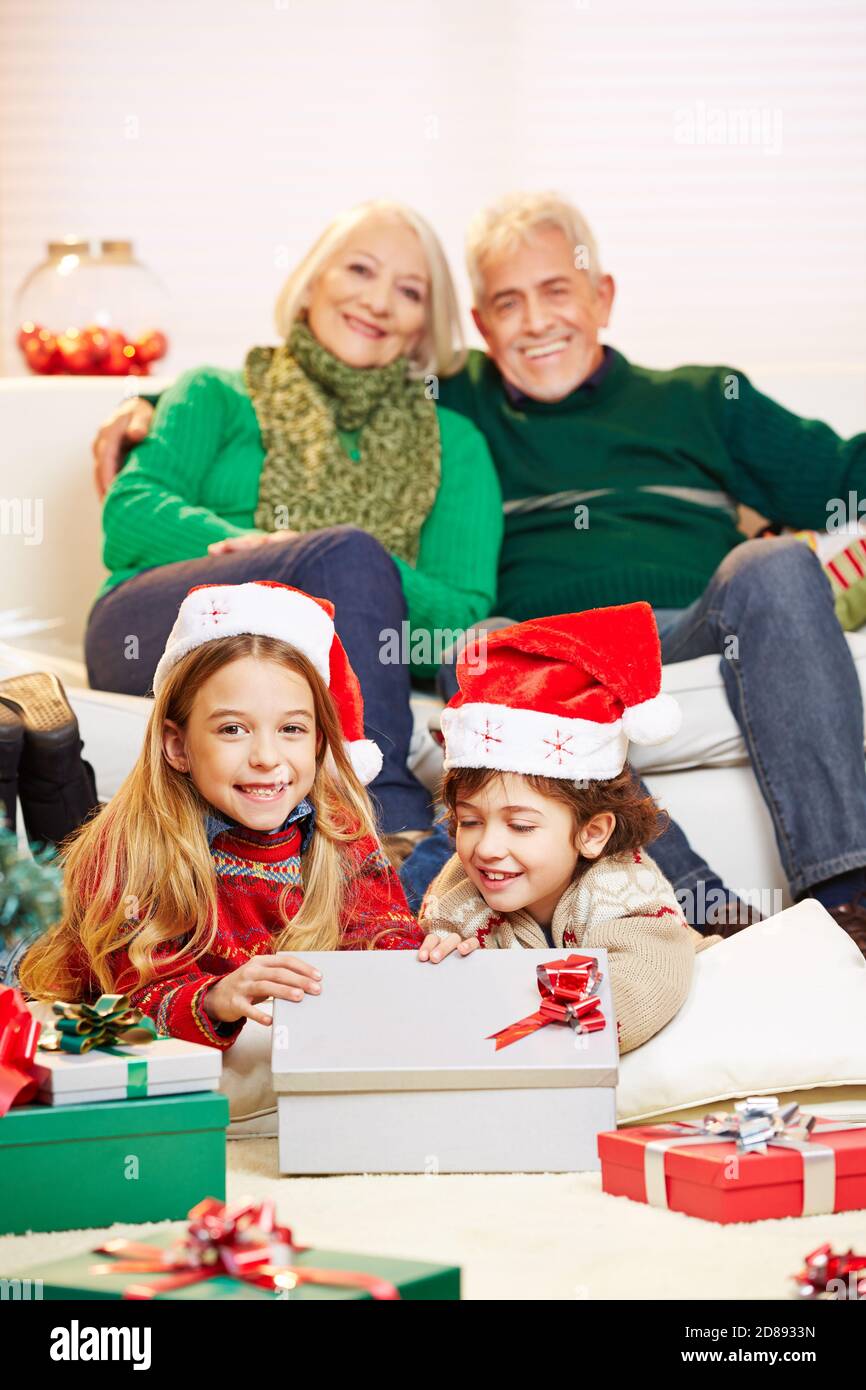 Two siblings unpack the grandparents' gifts for Christmas Stock Photo