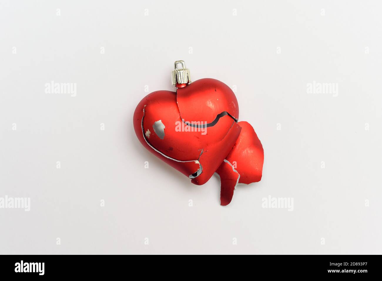 Broken heart Red heart isolated on white background as symbol of break up in relationship Stock Photo