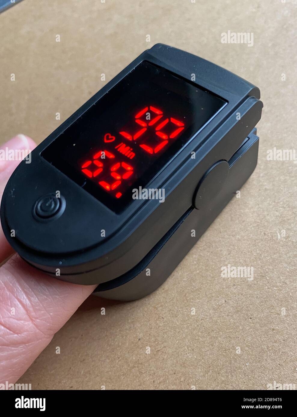 Measuring heart rate and blood oxygen saturation level using a pulse oximeter. Stock Photo