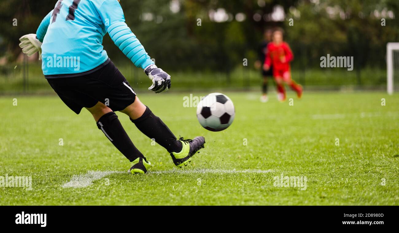 Young Soccer Goalie Kicking Ball. Football Goalkeeper Starts Game