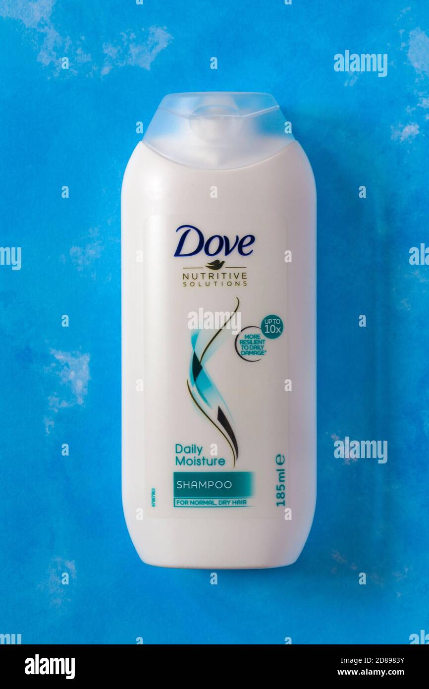 bottle of Dove Nutritive Solutions Daily Moisture Shampoo set on blue