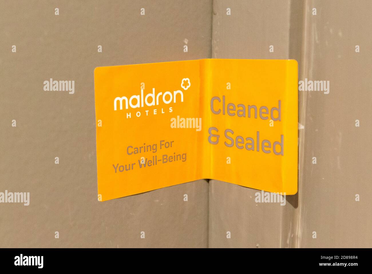 Covid Ireland airport quarantine and orange sticker on Maldron Hotel sealed room door as proof for the room has been cleaned during the Covid 19 pandemic outbreak in Maldron Hotel Dublin Airport Ireland Europe as of October 2020. Stock Photo