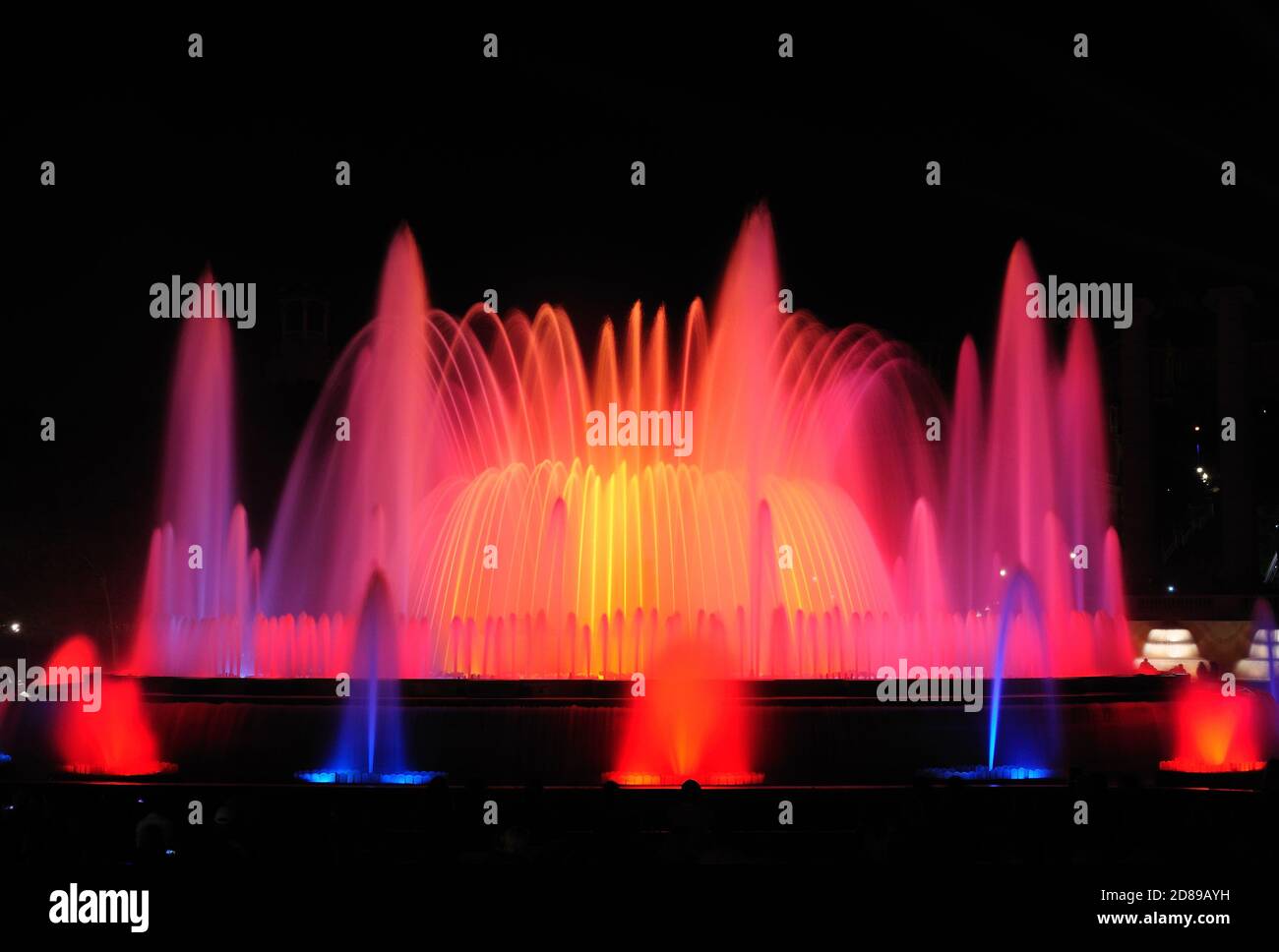 Night show of Magic Fountain of Montjuïc - spectacular display of color, light, music and water motion. The popular tourist attraction of the city. Stock Photo