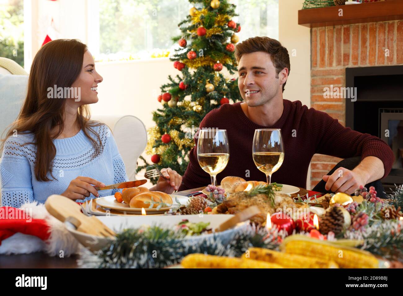 Young couple having christmas dinner together Stock Photo