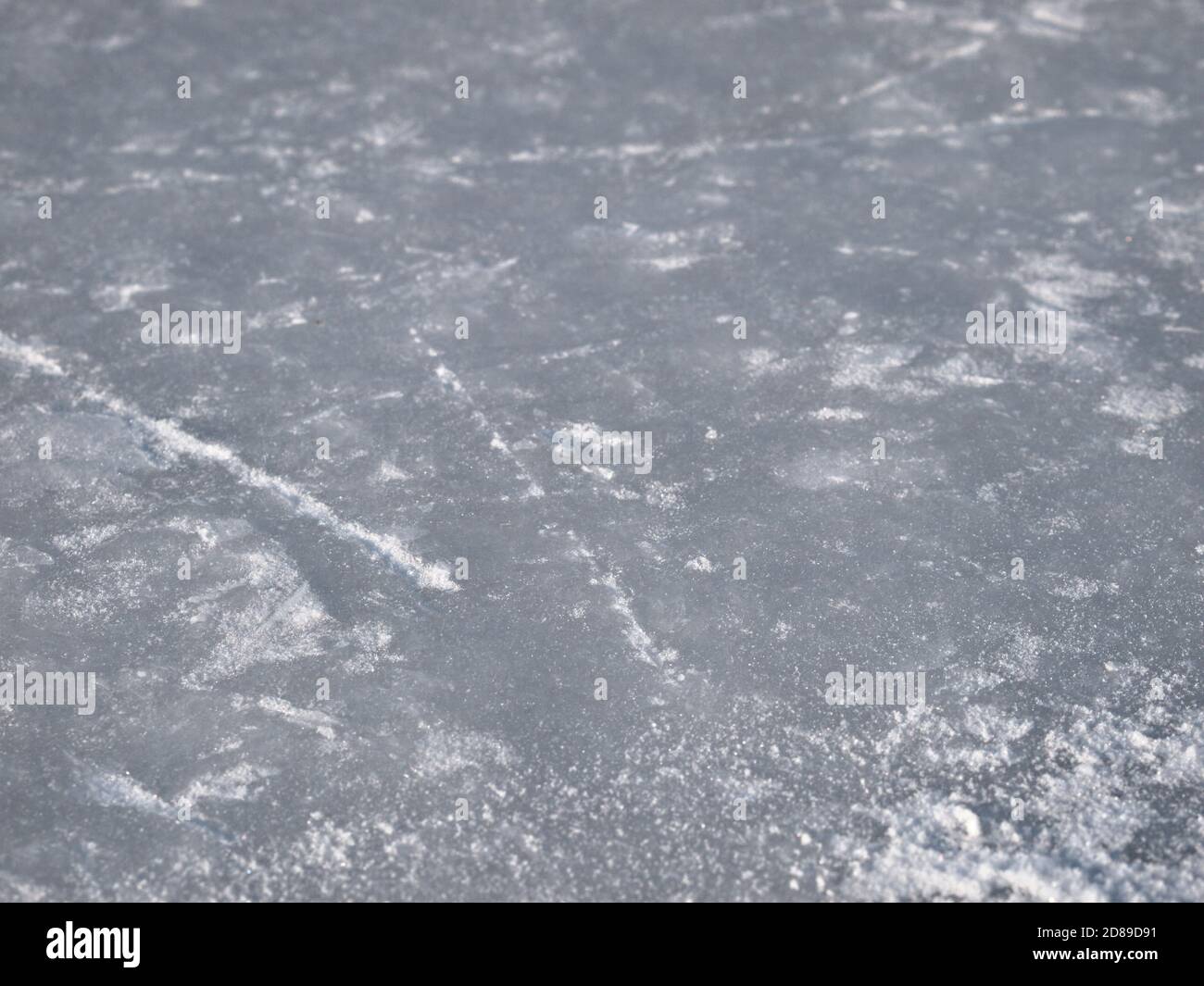 Ice rink surface background with selective focus,  hockey and figure skates tracks and scratches texture Stock Photo