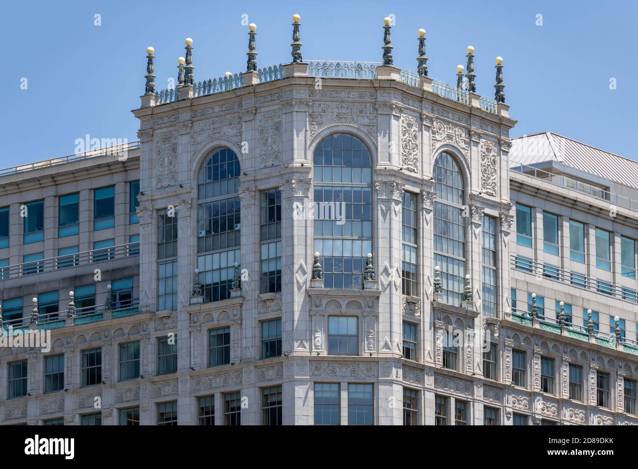 Ornate pinnacle lighting and an art deco balustrade of dancing girls tops the facade of the Warner (originally Earle) Theatre in Washington DC. Stock Photo