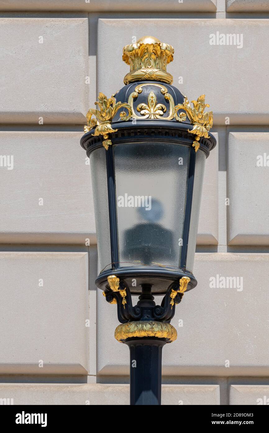 Ornate gilt fleur-de-lis and acanthus leaves decorate a black street lamp by the EPA's Clinton Building on Constitution Avenue in Washington DC. Stock Photo