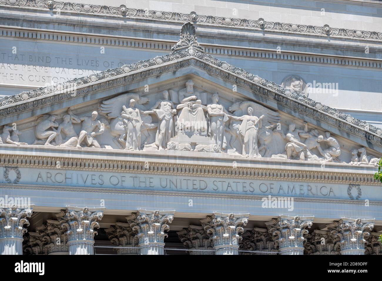 James Earle Fraser's 'Recorder of the Archive' fills the ornate pediment over the entrance to John Russell Pope's National Archives Building. Stock Photo