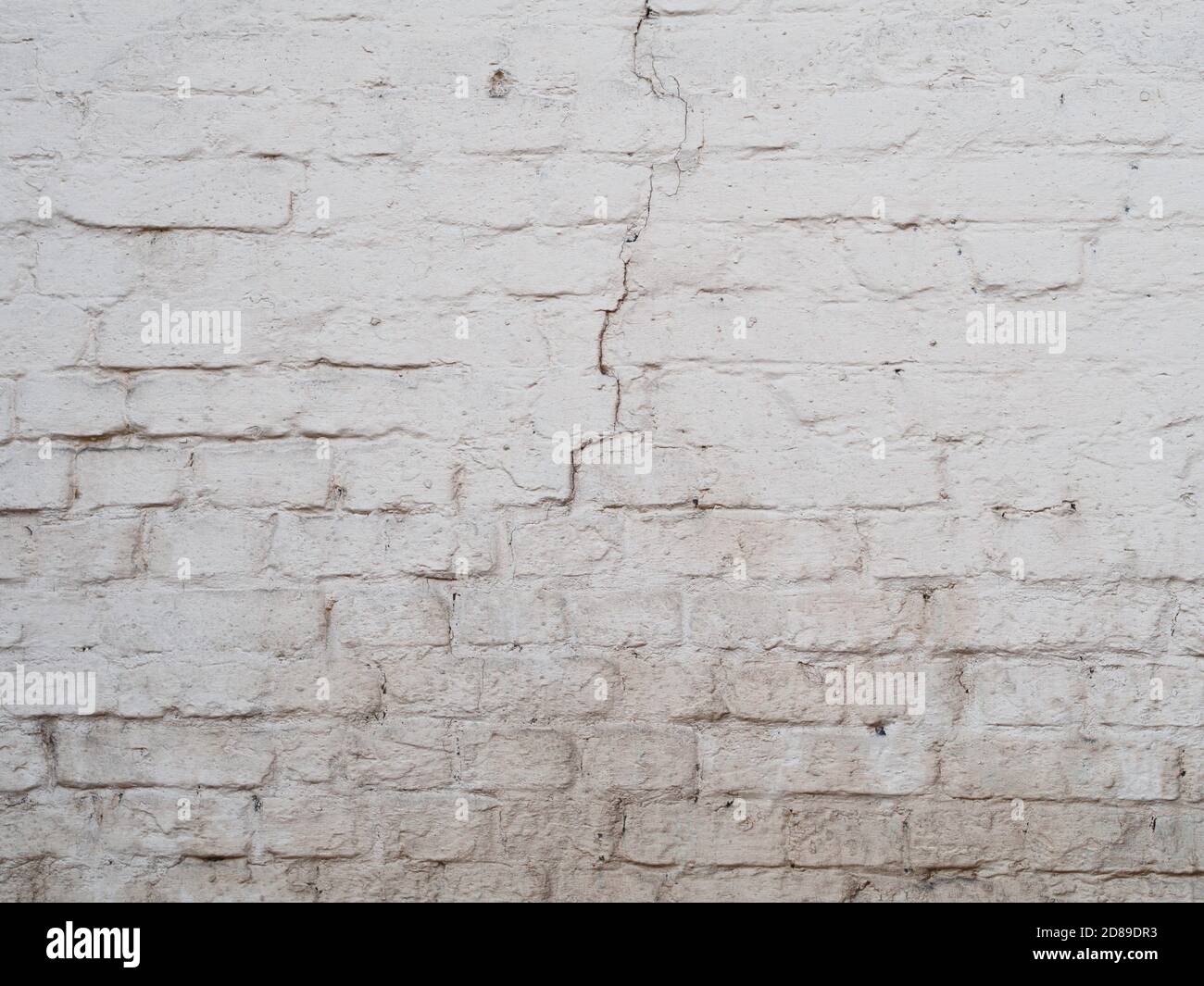 White cracked brick wal background, painted surface texture Stock Photo