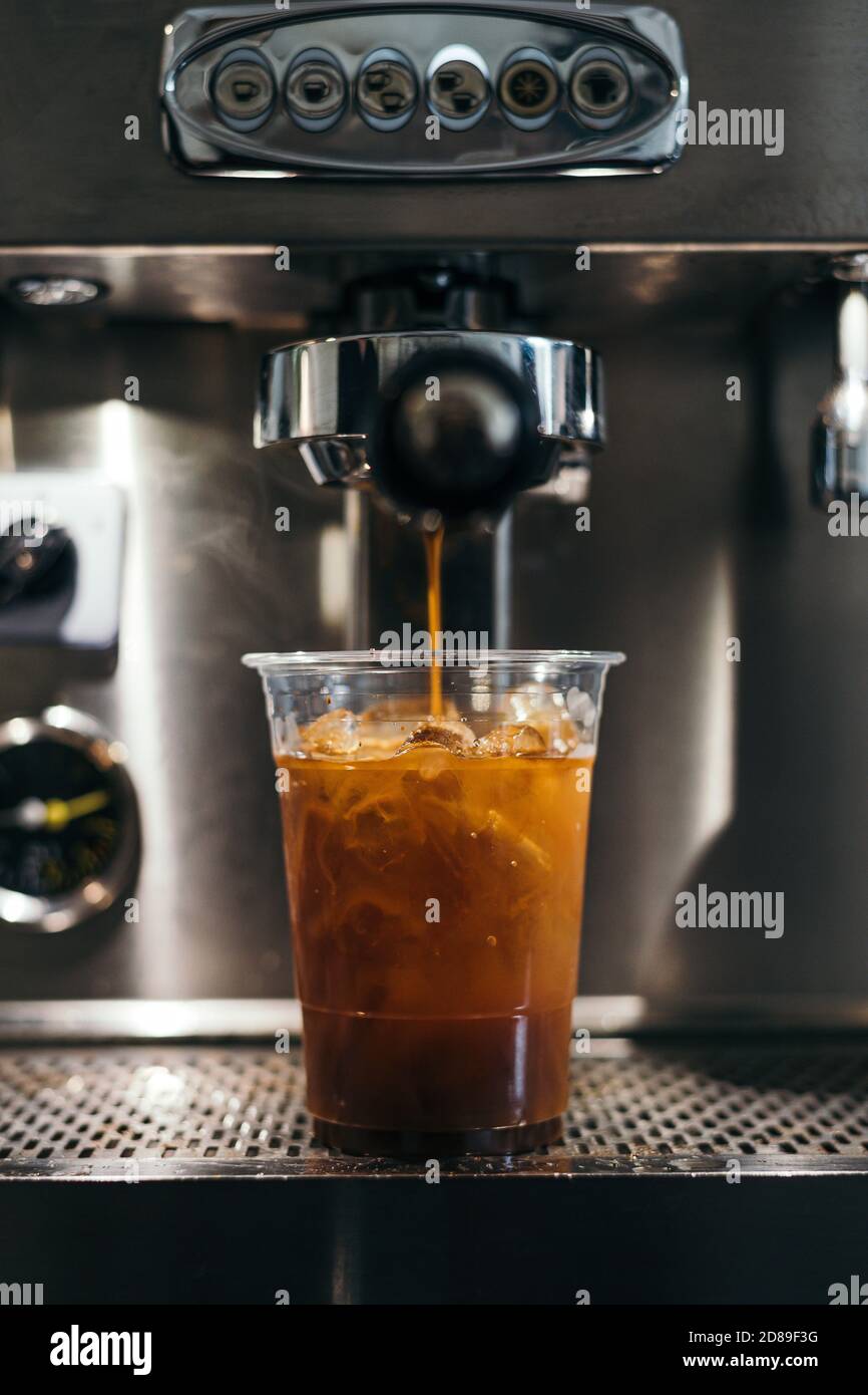 https://c8.alamy.com/comp/2D89F3G/iced-american-coffee-brewing-in-plastic-cup-on-coffee-machine-2D89F3G.jpg