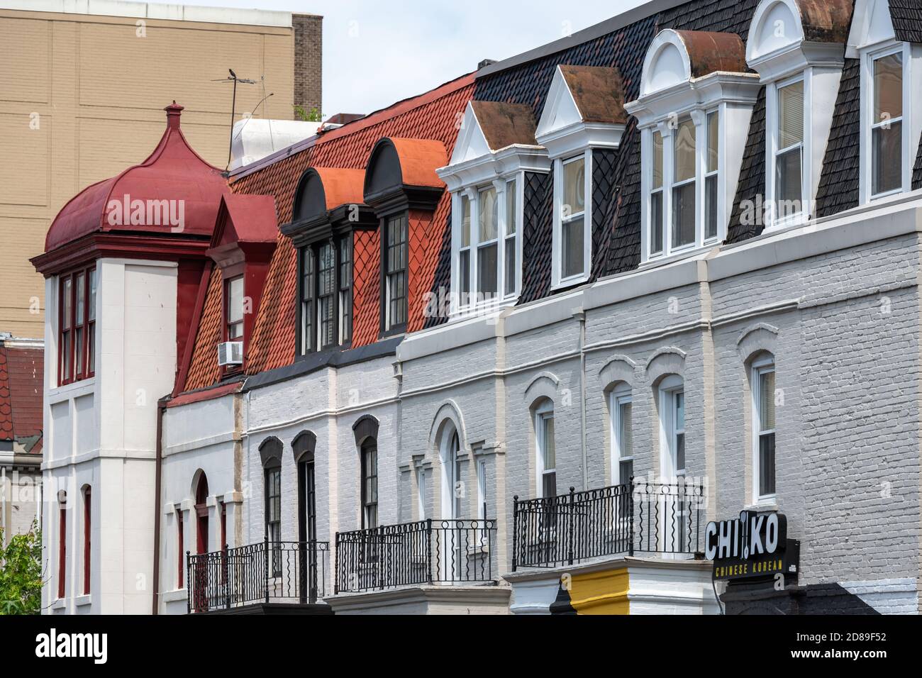 Contrasting window styles decorate a row of houses in P St NW in Washington DC Stock Photo