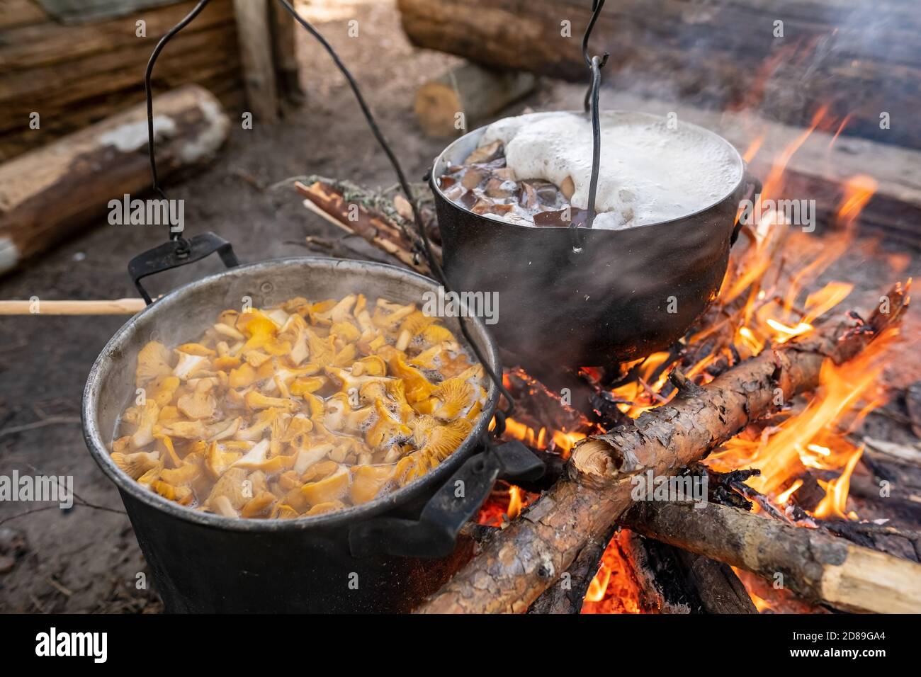 camping cooking on campfire with old iron pots Stock Photo - Alamy