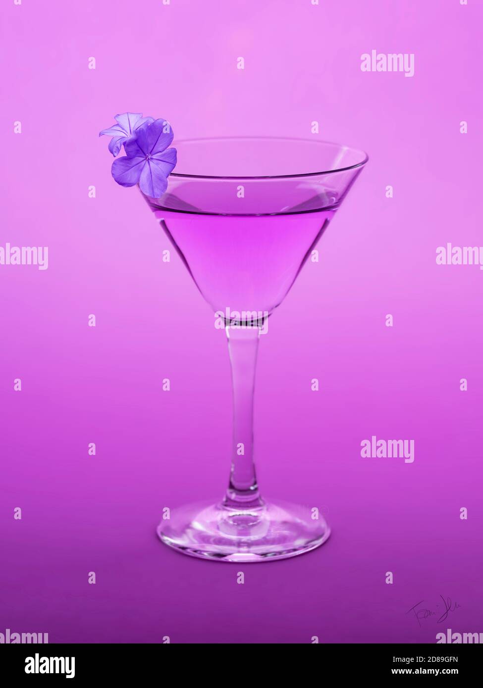 Conceptual purple cocktail with a violet flower blossom Stock Photo