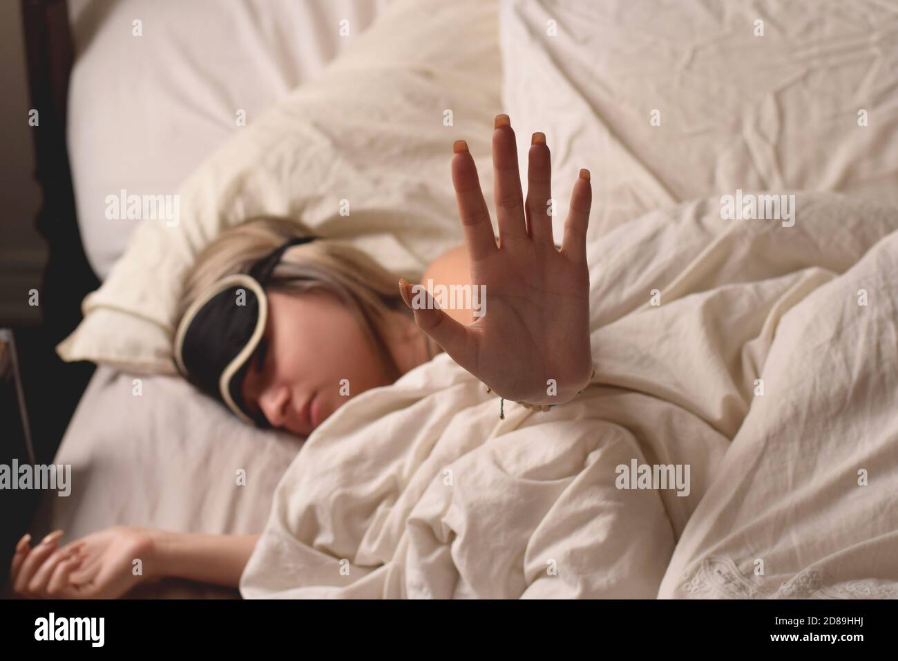 Teenage girl wearing an eye mask in bed wanting to be left alone Stock