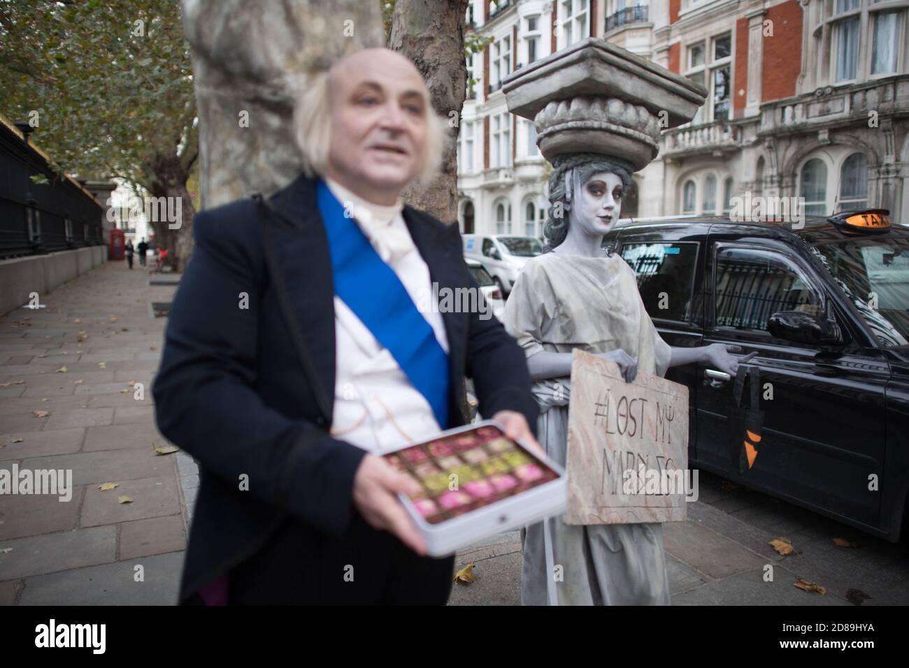 Campaigners dressed as Lord Elgin and a Parthenon Marble hand out