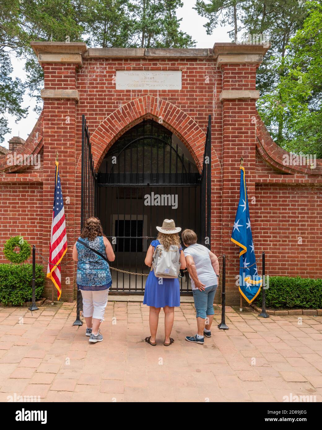 Three women pay their respects at the 1831 New Tomb of George Washington, his wife Martha and various family members  at Mount Vernon, Virginia. Stock Photo