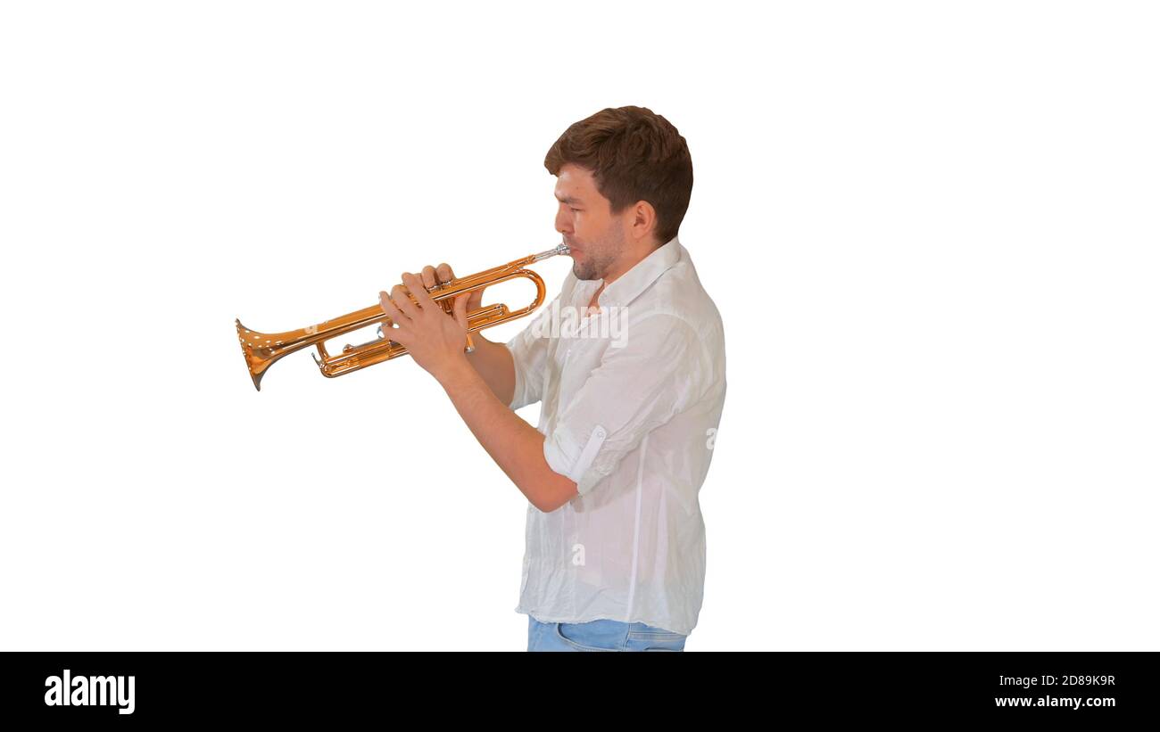 Young musician playing the trumpet on white background. Stock Photo
