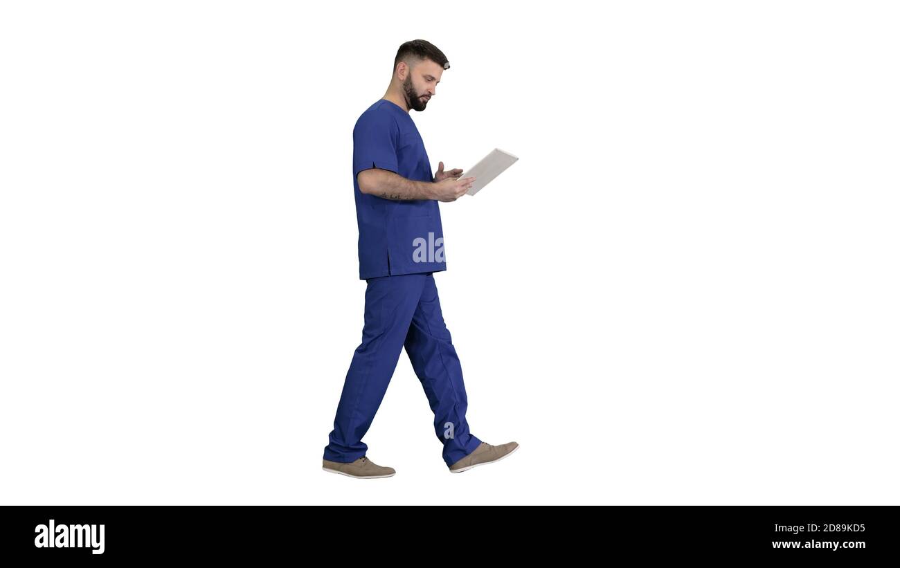 Confident concentrated focused surgeon using digital tablet on w Stock Photo