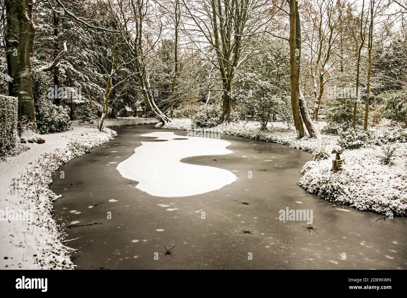 Rotterdam, The Netherlands, January 22, 2020: pond in Schoonoord Park on a winter day, covered with ice, snow and slush Stock Photo