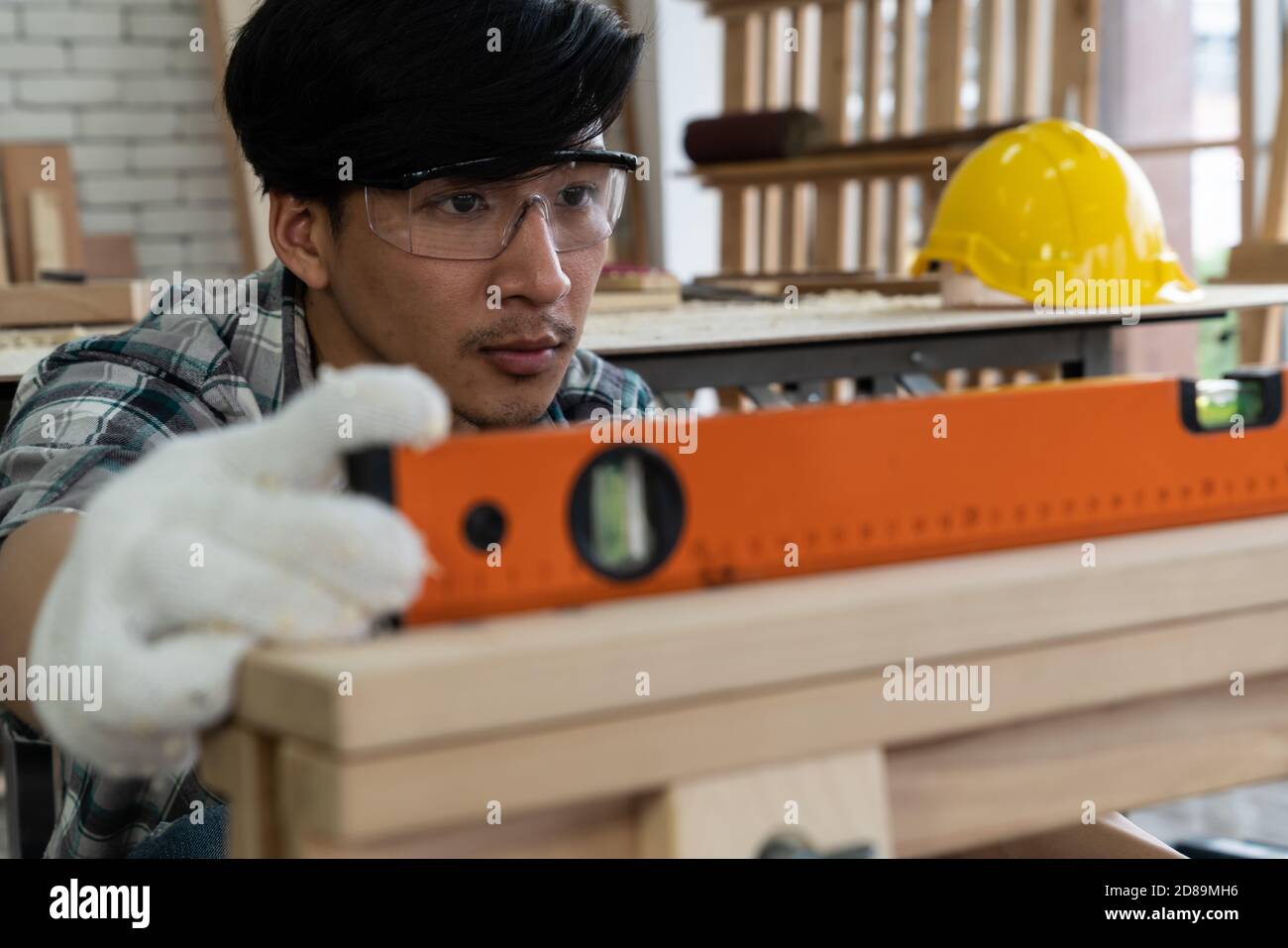 Carpenter working on wood craft at to produce construction