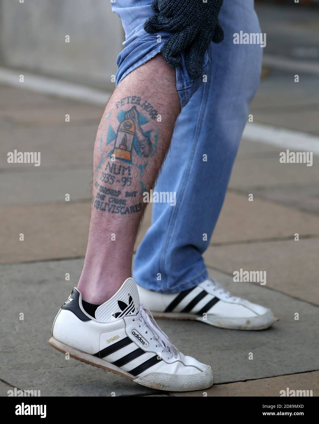 A former miner shows his tattoo outside the Scottish Parliament, Edinburgh, ahead of Scottish Government's response to recommendations made by the Independent Review of the of 1984/85 Miners' Strike.