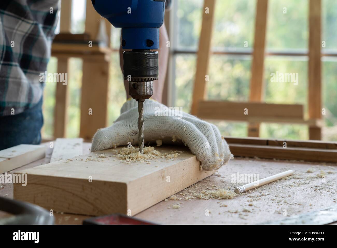 Carpenter working on wood craft at to produce construction
