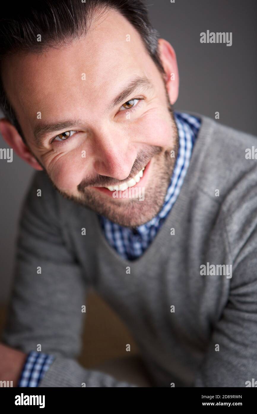 Close up portrait of smiling businessman against gray background Stock ...