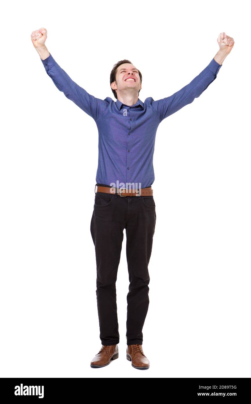 Full length portrait of carefree young man standing with arms outstretched in joy Stock Photo